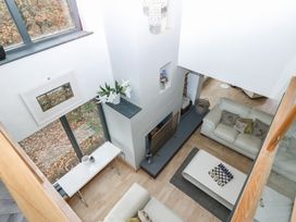 A living room with a fireplace and seating area at Chapel Hill in Catlowdy