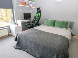 A bedroom with a bed, desk, and chair at Chapel Hill in Catlowdy