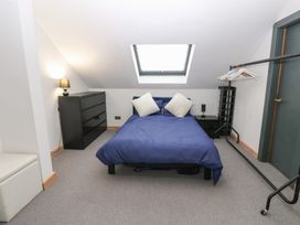 A bedroom with a bed and dresser at Chapel Hill Catlowdy