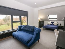 A bedroom with a sofa and bed at Chapel Hill in Catlowdy