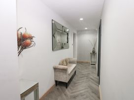 A hallway with a mirror and couch at Chapel Hill in Catlowdy