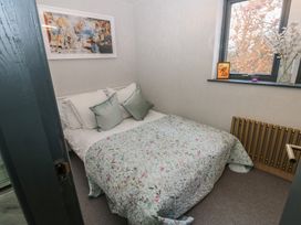 A bedroom with a bed and wall art at Chapel Hill in Catlowdy