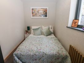 A bedroom with a bed and nightstand at Chapel Hill in Catlowdy