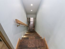 A staircase with stone steps and a handrail at Chapel Hill in Catlowdy