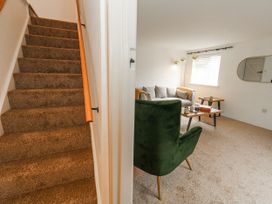 A living room with a sofa and coffee table at Long Barn in Burton Bradstock