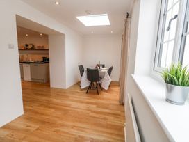 A kitchen with dining area and a window at Long Barn in Burton Bradstock
