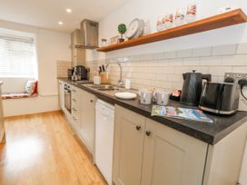 A kitchen with appliances and utensils at Long Barn in Burton Bradstock