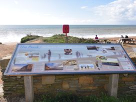 A sign with information at Hive Beach in Burton Bradstock