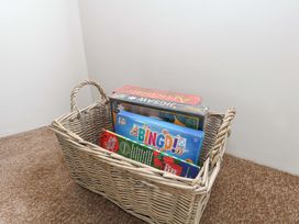 A basket with board games in Long Barn Burton Bradstock