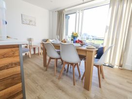 A dining room with a table and chairs at Seafern House 36B in Poole
