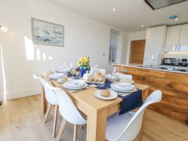 A dining room with a table set for a meal at Seafern House 36B Poole