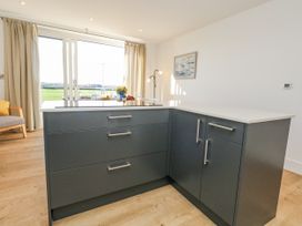 A kitchen with an island and drawers at Seafern House 36B Poole