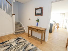 A hallway with a table and vase at Seafern House 36B in Poole