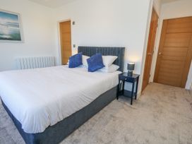 A bedroom with a bed and a bedside table at Seafern House 36B in Poole
