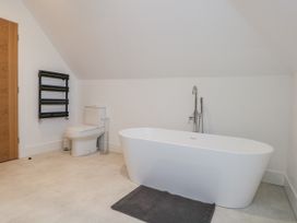 A bathroom with a bathtub and toilet at Seafern House 36B Poole