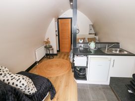 A studio with a kitchenette and bed at Cwtch Bach in Aberdare