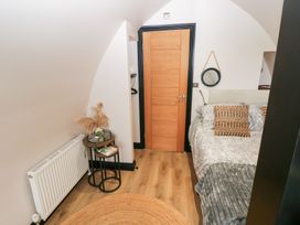 A bedroom with a bed and side table at Cwtch Bach in Aberdare