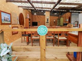 An outdoor seating area with tables and chairs at Cwtch Bach Aberdare