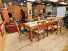A dining room with a table and chairs at Cwtch Bach in Aberdare