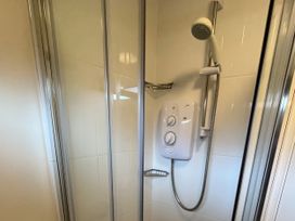 A shower with a glass enclosure and a shower valve at Stanbury