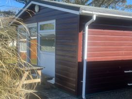 A wooden building with a table outside at Stanbury