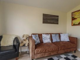 A living room with a sofa and armchair at Stanbury in St Merryn