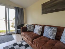 A living room with a sofa and pillows at Stanbury in St Merryn