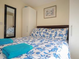 A bedroom with a bed and wardrobe at Stanbury in St Merryn