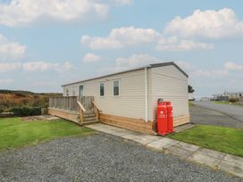 A mobile home with a deck and gas cylinders at Peaceful in Stranraer