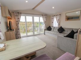 A living room with a sofa and television at Peaceful in Stranraer