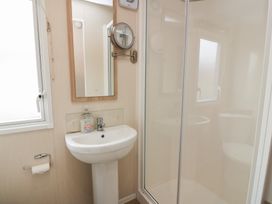 A bathroom with a sink and shower at Peaceful in Stranraer