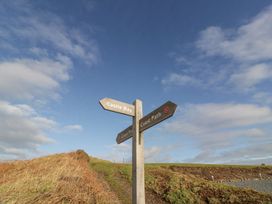 A signpost indicating directions to Castle Bay and Coast Path at Peaceful in Stranraer