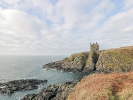 A ruined building on a cliff overlooking the ocean at Peaceful in Stranraer