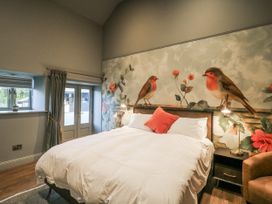 A bedroom with a bed and wall art at Robins Rest at The Lodge in Kilmacthomas