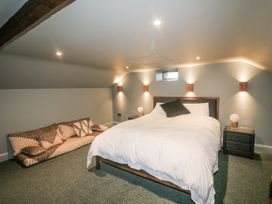 A bedroom with a bed and sofa at Robins Rest at The Lodge Kilmacthomas