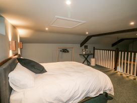A loft bedroom with a bed and clothing hangers at Robins Rest at The Lodge Kilmacthomas