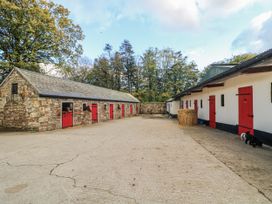 An outdoor stable area with doors and horses at Robins Rest at The Lodge in Kilmacthomas