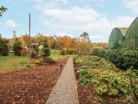 A garden with a gravel path and trees at Robins Rest at The Lodge Kilmacthomas
