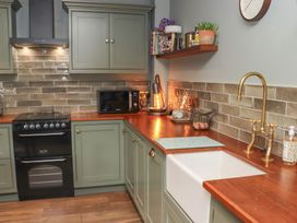 A kitchen with cabinets, sink, oven, and microwave at Robins Rest at The Lodge Ahanaglogh near Kilmacthomas, County Waterford