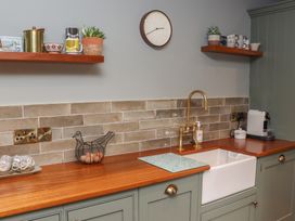 A kitchen with a sink, faucet, and various utensils at Robins Rest at The Lodge Ahanaglogh near Kilmacthomas, County Waterford
