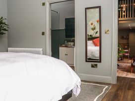 A bedroom with a bed and a mirror at Robins Rest at The Lodge in Ahanaglogh near Kilmacthomas, County Waterford