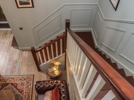 An entryway with a staircase and a sofa at Robins Rest at The Lodge Ahanaglogh near Kilmacthomas County Waterford