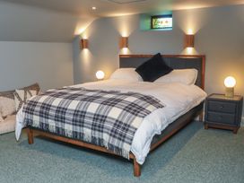 A bedroom with a bed, bedside table, and lamp at Robins Rest at The Lodge, Ahanaglogh near Kilmacthomas, County Waterford