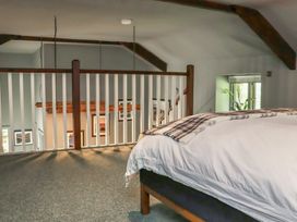 A bedroom with a bed and railing overlooking a staircase at Robins Rest at The Lodge Ahanaglogh near Kilmacthomas, County Waterford