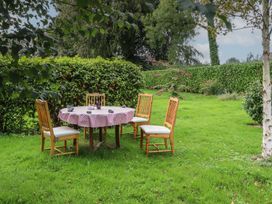 A table with chairs in a garden at Robins Rest at The Lodge Ahanaglogh near Kilmacthomas, County Waterford