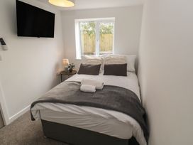 A bedroom with a bed and television at Cosy Retreat in 