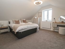 A bedroom with a bed and bedside table at Cosy Retreat in 