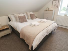 A bedroom with a bed and nightstand at Cosy Retreat in 