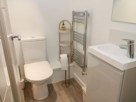 A bathroom with a toilet, sink, and towel rail at Cosy Retreat