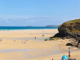 A beach with people and rocks at Cosy Retreat